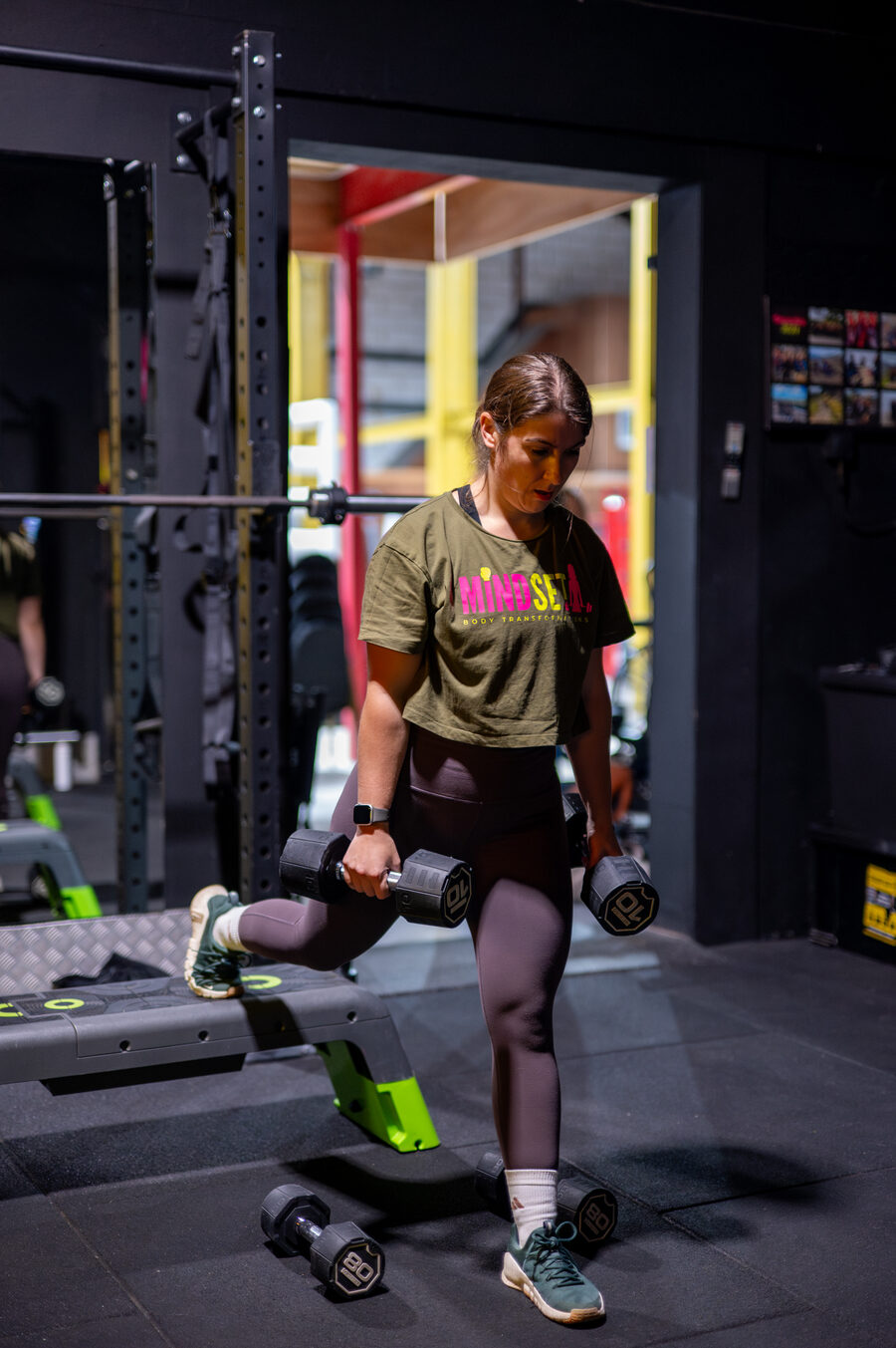 Woman lifting dumbbells at Mindset Body Transformations